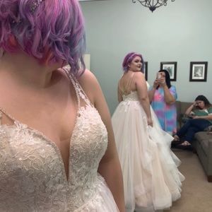 Stella York wedding gown with lace overlay and beaded design.